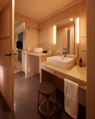 a bathroom with a sink and a large mirror at Sakura Sky Hotel in Tokyo