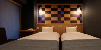 two beds sitting next to each other in a room at Sakura Sky Hotel in Tokyo