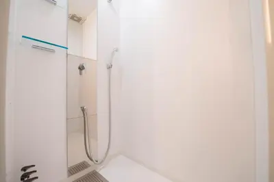 a shower with a glass door in a bathroom at Sakura Sky Hotel in Tokyo