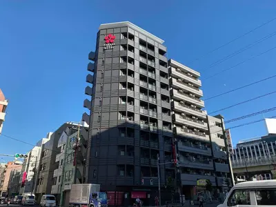 a tall building with a clock on top of it at Sakura Sky Hotel in Tokyo