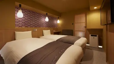 a hotel room with two beds in a room at Sakura Sky Hotel in Tokyo