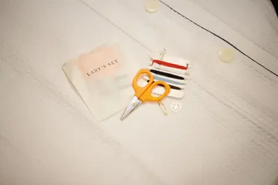 a pair of scissors sitting on top of a shirt at Sotetsu Fresa Inn Ueno-Okachimachi in Tokyo