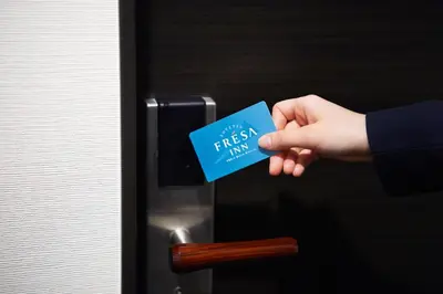 a person is holding a blue piece of paper at Sotetsu Fresa Inn Ueno-Okachimachi in Tokyo