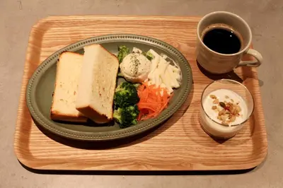 a tray with a plate of food and a cup of coffee at Sotetsu Fresa Inn Ueno-Okachimachi in Tokyo