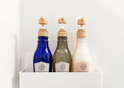 three bottles of wine sitting on a white shelf at G-stays Shinjuku in Tokyo