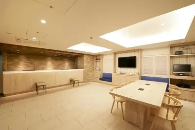 a kitchen with a table and chairs in a room at Sotetsu Fresa Inn Ginza Sanchome in Tokyo