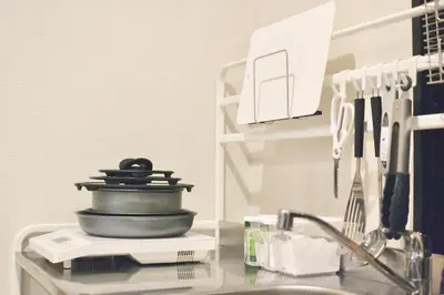 a kitchen sink with a pan on a shelf at TOKYO-W-INN Asakusa in Tokyo