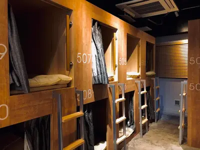 a row of bunk beds in a room at TOKYO-W-INN Asakusa in Tokyo
