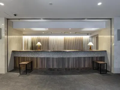 a lobby with a bar and two benches at Tokyu Stay Yotsuya - Shinjuku Area in Tokyo