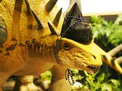 a toy dinosaur with a hat on its head at Henn na Hotel Tokyo Nishikasai in Tokyo