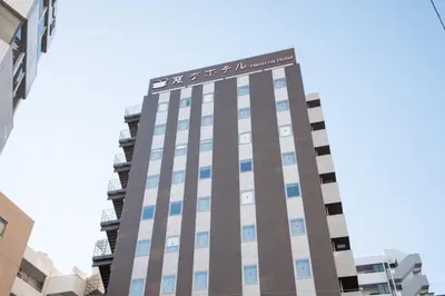 a tall building with a sign on top of it at Henn na Hotel Tokyo Nishikasai in Tokyo