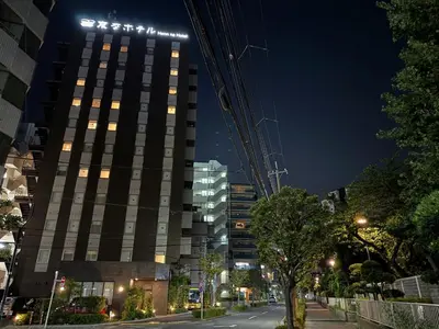 a tall building with lights on top at night at Henn na Hotel Tokyo Nishikasai in Tokyo