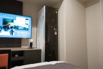 a bedroom with a flat screen tv and a bed at Henn na Hotel Tokyo Nishikasai in Tokyo