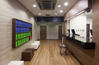 a lobby of an office with a bar and chairs at FLEXSTAY INN Sugamo in Tokyo