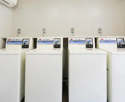 a row of cell phones on display in a room at FLEXSTAY INN Sugamo in Tokyo