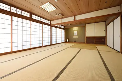a large room with large windows and a wooden ceiling at Belmont Hotel in Tokyo