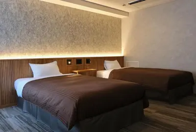 a hotel room with two beds in a room at Belmont Hotel in Tokyo
