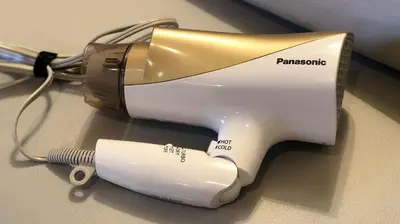 a hair dryer sitting on a table with a brush at Restay Frontier (Adult Only) in Tokyo