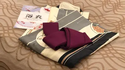 a pile of purple ties sitting on top of a bed at Restay Frontier (Adult Only) in Tokyo