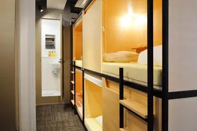 a small room with a bed and a bathroom at Tokyo Tower View Guest House in Tokyo