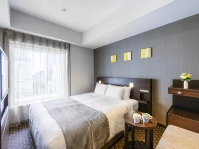 a hotel room with a bed and a window at Akihabara Washington Hotel in Tokyo