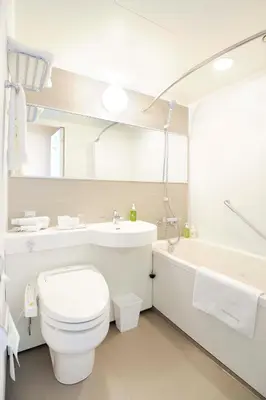 a bathroom with a toilet and a sink and a tub at Akihabara Washington Hotel in Tokyo