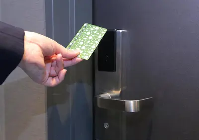 a hand holding a remote control on a refrigerator at Akihabara Washington Hotel in Tokyo