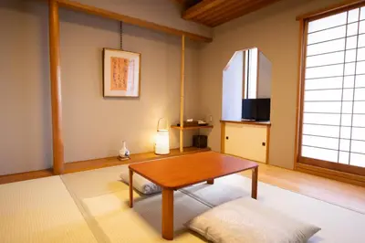a living room with a table and a window at Ryokan Asakusa Shigetsu in Tokyo