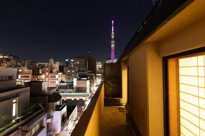 a view of a city at night with a tv tower at Ryokan Asakusa Shigetsu in Tokyo