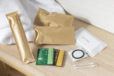 a table topped with brown paper bags on a bed at Tokyu Stay Yoga in Tokyo