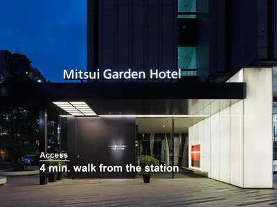 a building with a sign that reads ahmhm walk from the station at Mitsui Garden Hotel Ginza Premier in Tokyo