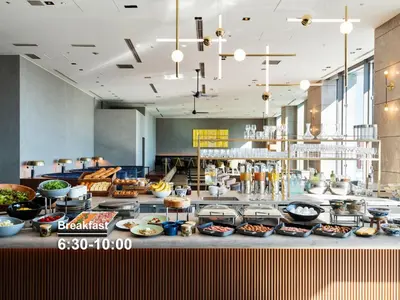 a buffet line with bowls and plates of food at Mitsui Garden Hotel Ginza Premier in Tokyo