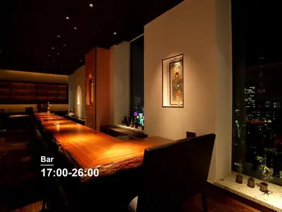 a bar with a long wooden table in a building at Mitsui Garden Hotel Ginza Premier in Tokyo