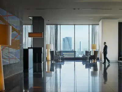a man walking through a lobby of a building at Mitsui Garden Hotel Ginza Premier in Tokyo