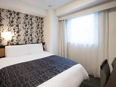 a hotel room with a bed and a window at APA Hotel Iidabashi Ekiminami in Tokyo