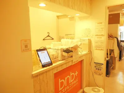 a shop with a counter with a cell phone on it at bnb+ Akihabara (Female Only) in Tokyo