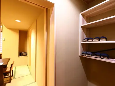 a room with some shelves with shoes on them at Ryokan Kamogawa Asakusa in Tokyo