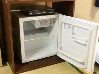 a refrigerator with its door open in a kitchen at Ryokan Kamogawa Asakusa in Tokyo