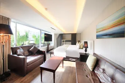 a hotel room with a bed and a couch at The Centurion Classic Akasaka in Tokyo