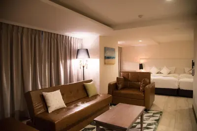 a hotel room with a couch and a bed at The Centurion Classic Akasaka in Tokyo