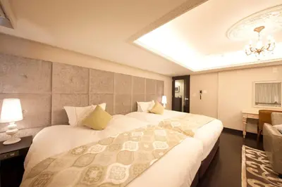a hotel room with two beds and a window at The Centurion Classic Akasaka in Tokyo