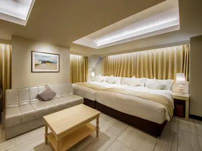 a hotel room with a large bed and a couch at The Centurion Classic Akasaka in Tokyo