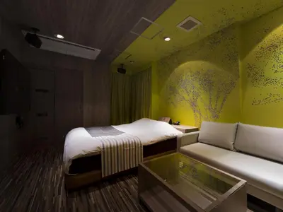 a hotel room with two beds and a couch at Hotel Crest Kinshicho (Adult Only) in Tokyo