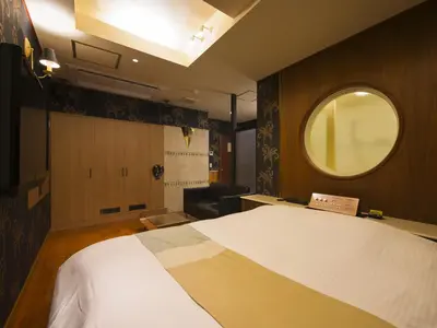 a bedroom with a large white bed and a window at Hotel Crest Kinshicho (Adult Only) in Tokyo