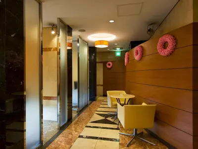 a hallway with a table and some donuts on the wall at Hotel Crest Kinshicho (Adult Only) in Tokyo
