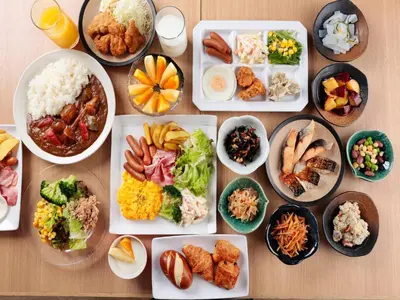 a table with many plates of food on it at Sotetsu Fresa Inn Tokyo Kinshicho in Tokyo