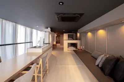 a kitchen and living room with a long dining table at AET & o3 HOTEL in Tokyo
