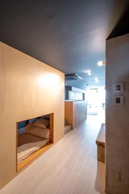 a bedroom with a bed on a wall at AET & o3 HOTEL in Tokyo