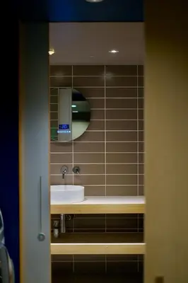 a bathroom with a sink and a mirror at AET & o3 HOTEL in Tokyo