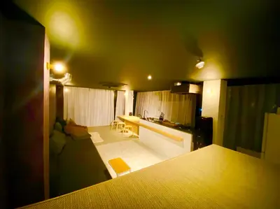 a living room with a couch and a kitchen at AET & o3 HOTEL in Tokyo